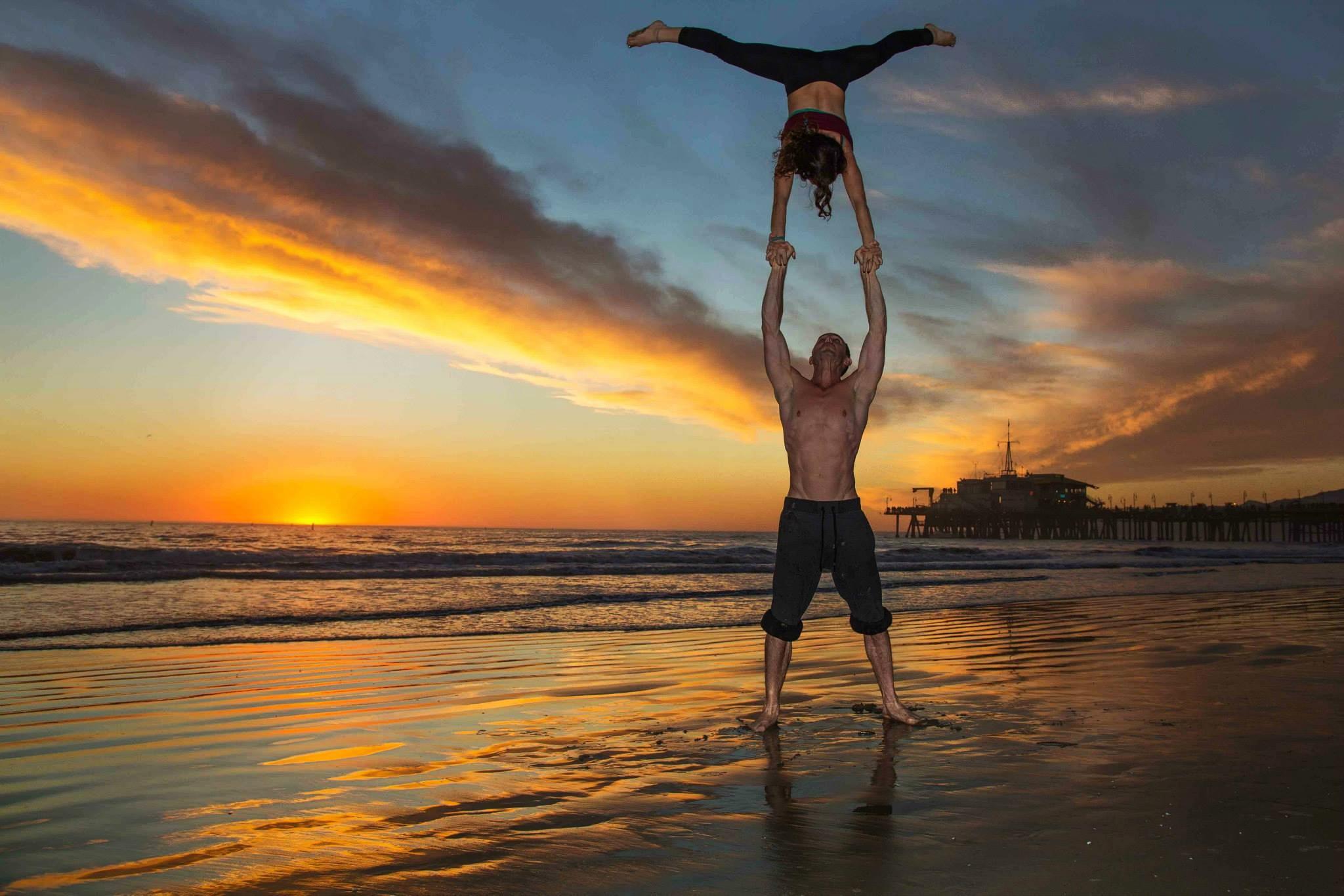 a yoga couple practicing acro-yoga